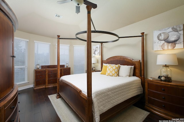 bedroom with a ceiling fan, visible vents, and dark wood finished floors