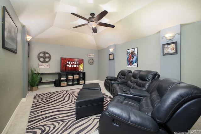 carpeted home theater featuring vaulted ceiling, baseboards, and ceiling fan