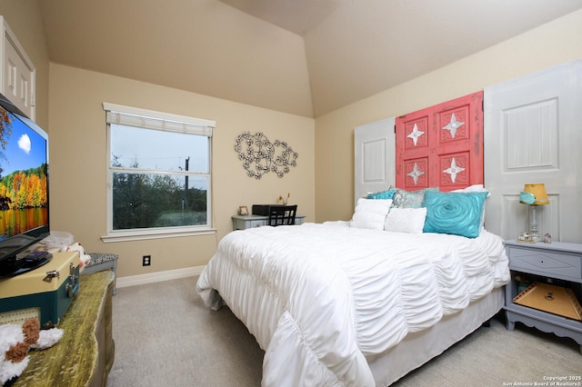 carpeted bedroom with lofted ceiling and baseboards