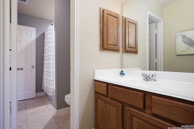 bathroom with visible vents, a shower with shower curtain, toilet, vanity, and tile patterned floors