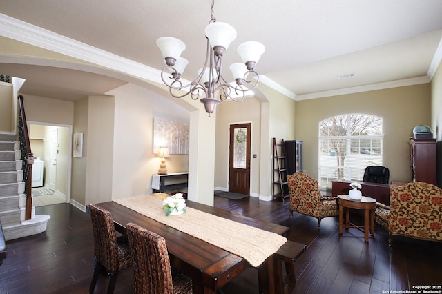 dining room with stairway, arched walkways, and hardwood / wood-style floors