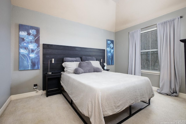 bedroom with light carpet and baseboards