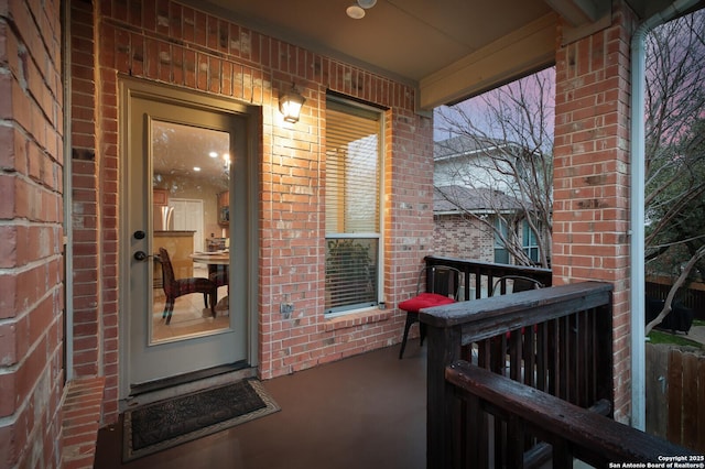 entrance to property featuring brick siding