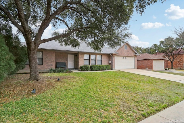 ranch-style home with a garage, driveway, brick siding, and a front yard