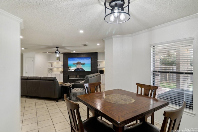 dining space featuring crown molding, recessed lighting, a ceiling fan, light tile patterned flooring, and a textured ceiling