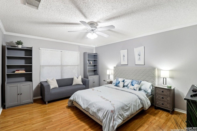 bedroom featuring ornamental molding, visible vents, and light wood-style flooring