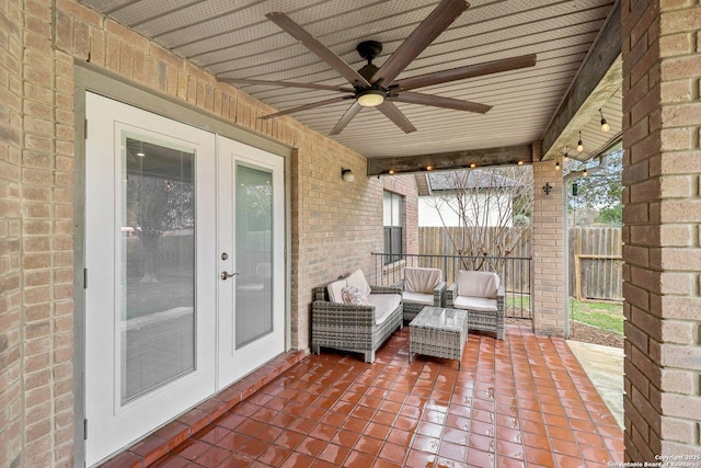 view of patio / terrace with french doors, an outdoor living space, fence, and a ceiling fan