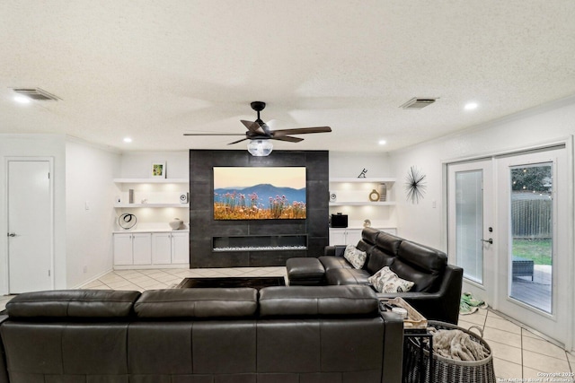 living area with light tile patterned floors, visible vents, a textured ceiling, and french doors