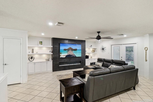 living area featuring light tile patterned floors, french doors, visible vents, and built in features