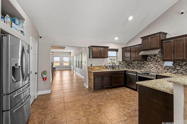 kitchen featuring a sink, stainless steel appliances, dark brown cabinets, under cabinet range hood, and backsplash