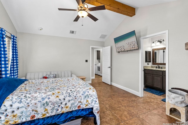 bedroom with visible vents, lofted ceiling with beams, a sink, ensuite bath, and baseboards