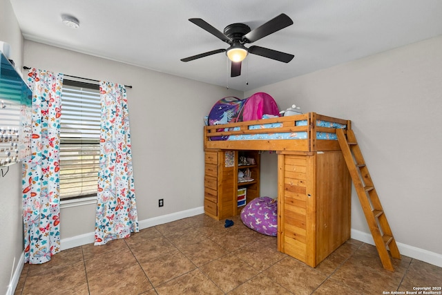 bedroom featuring tile patterned floors, baseboards, and ceiling fan