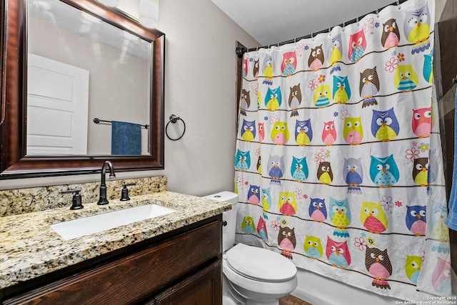 bathroom featuring toilet, vanity, and shower / bath combo