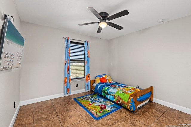 tiled bedroom with baseboards and ceiling fan