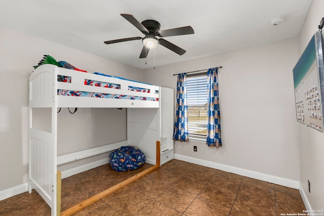 unfurnished bedroom featuring ceiling fan and baseboards