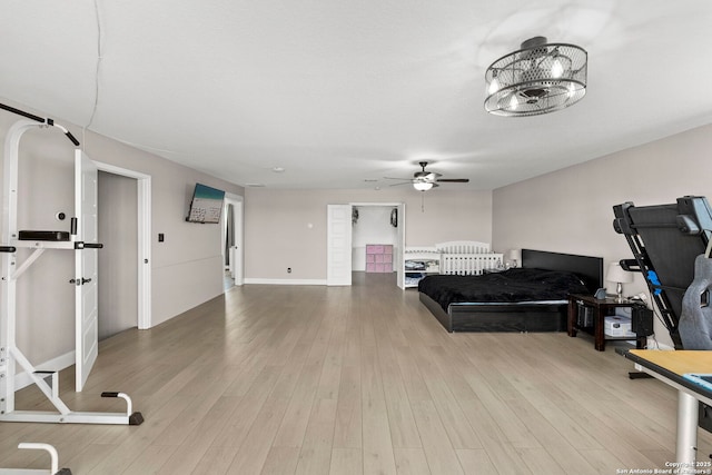 exercise room with wood finished floors and ceiling fan