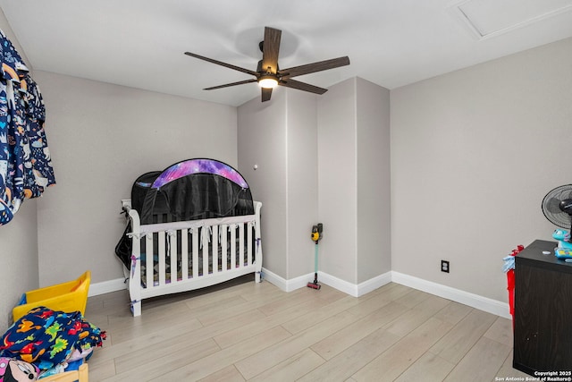 bedroom featuring baseboards, wood finished floors, and a ceiling fan