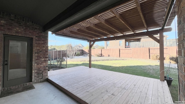 wooden terrace with a fenced backyard, a lawn, and a pergola