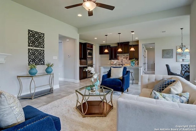 living area with light tile patterned floors, ceiling fan, recessed lighting, visible vents, and baseboards