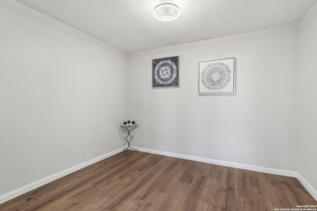 empty room with wood finished floors and baseboards