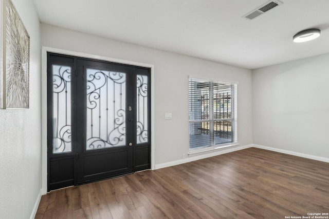 entrance foyer with baseboards, visible vents, and wood finished floors