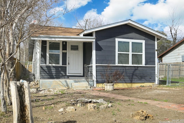 bungalow-style home featuring fence