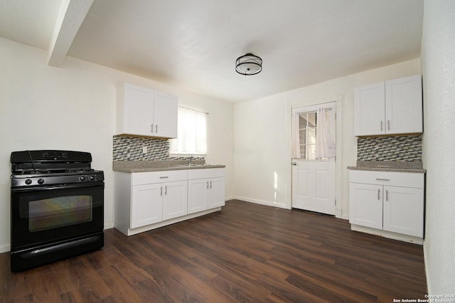 kitchen with gas stove, dark wood-style flooring, white cabinets, and backsplash