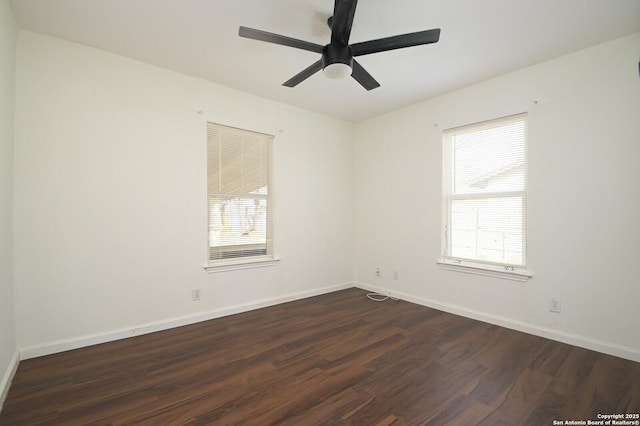 empty room featuring dark wood-style floors, ceiling fan, and baseboards