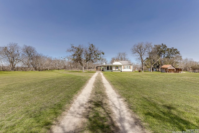 view of front of home with driveway and a front lawn