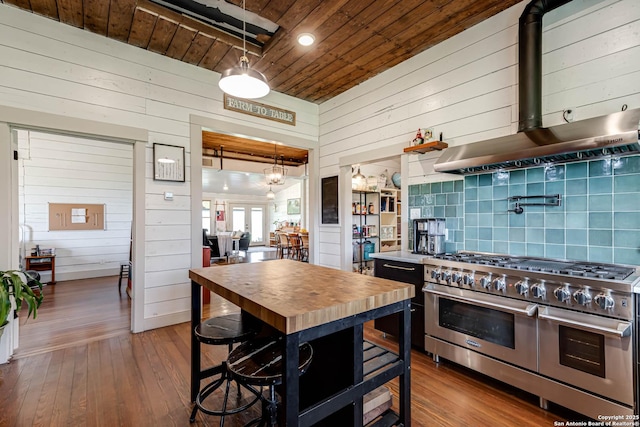 kitchen with tasteful backsplash, wooden ceiling, double oven range, wall chimney exhaust hood, and hardwood / wood-style flooring