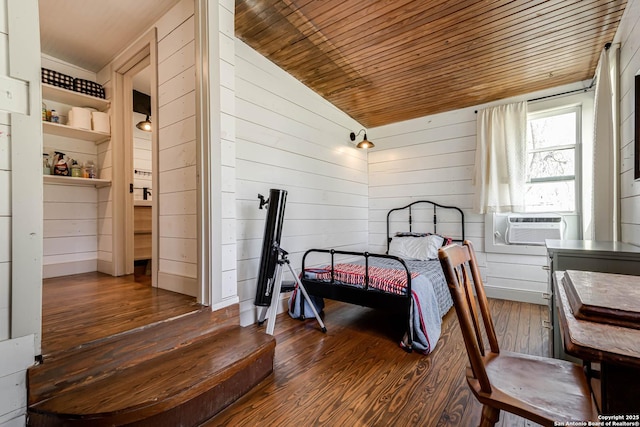 bedroom with wood-type flooring, vaulted ceiling, wooden walls, cooling unit, and wooden ceiling