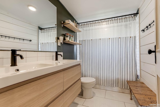 bathroom with toilet, double vanity, a sink, and tile patterned floors