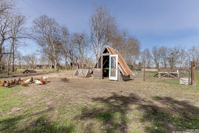 view of yard featuring exterior structure and an outdoor structure