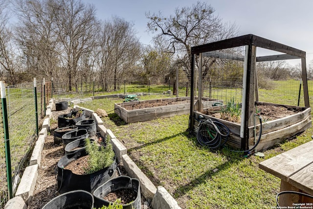 view of yard featuring a vegetable garden and fence