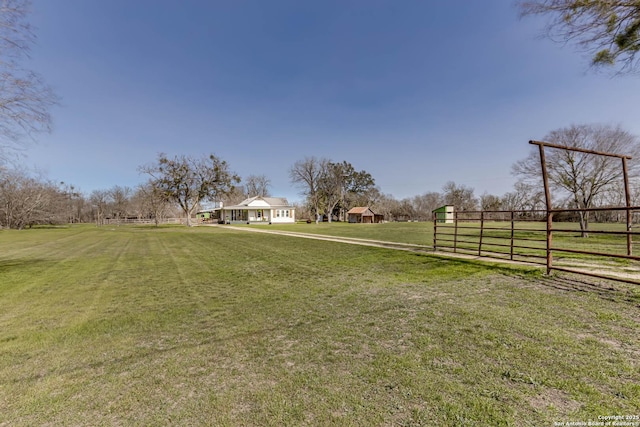 view of yard featuring a rural view and fence