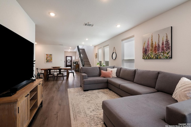 living room featuring recessed lighting, visible vents, stairway, and wood finished floors