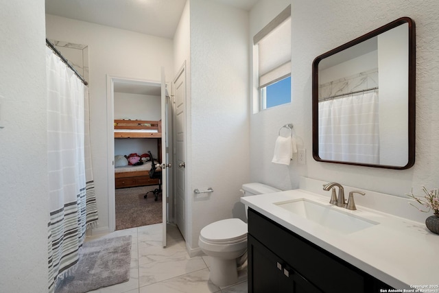 full bath featuring marble finish floor, vanity, and toilet