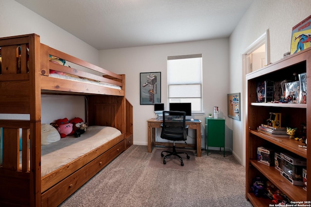 carpeted bedroom featuring baseboards