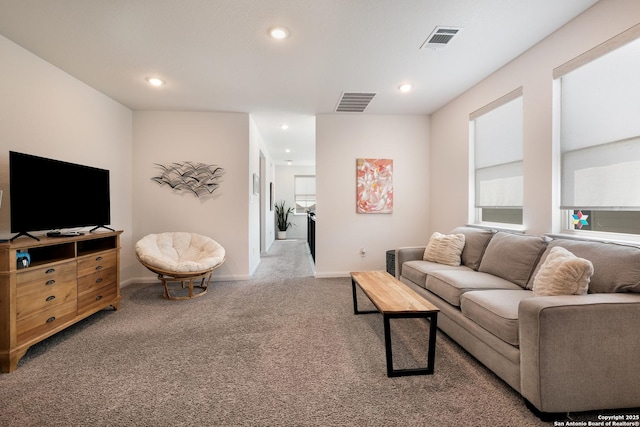 carpeted living room with recessed lighting, visible vents, and baseboards