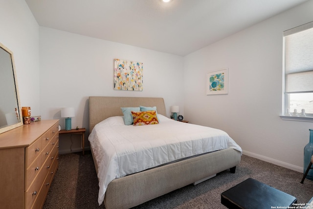 carpeted bedroom featuring baseboards