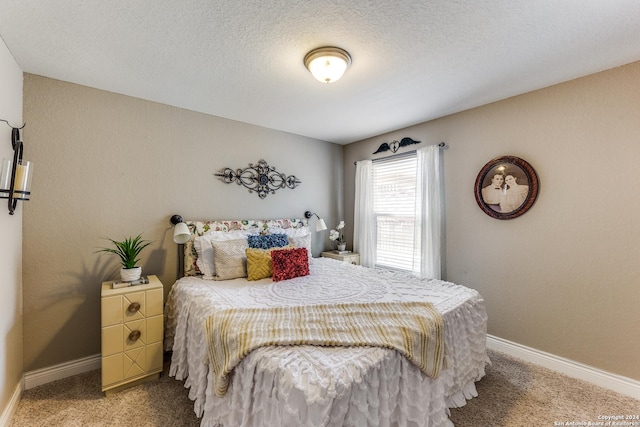 bedroom featuring baseboards, a textured ceiling, and light colored carpet