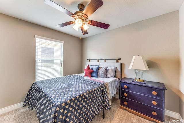 bedroom featuring carpet, baseboards, and a ceiling fan