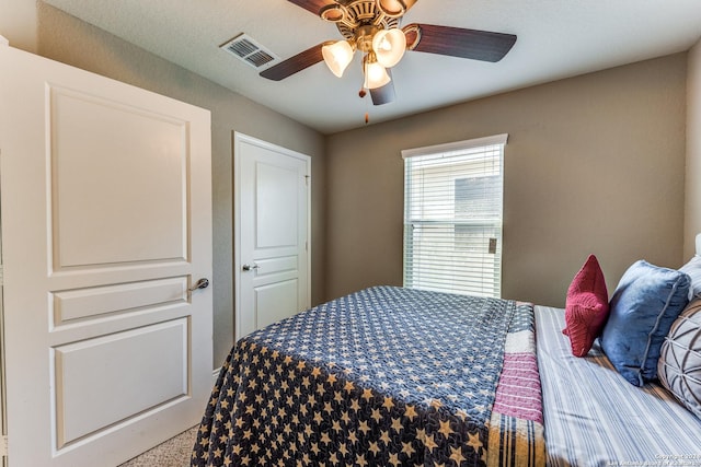 bedroom with ceiling fan and visible vents