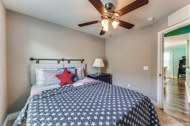 bedroom with a ceiling fan, visible vents, and baseboards