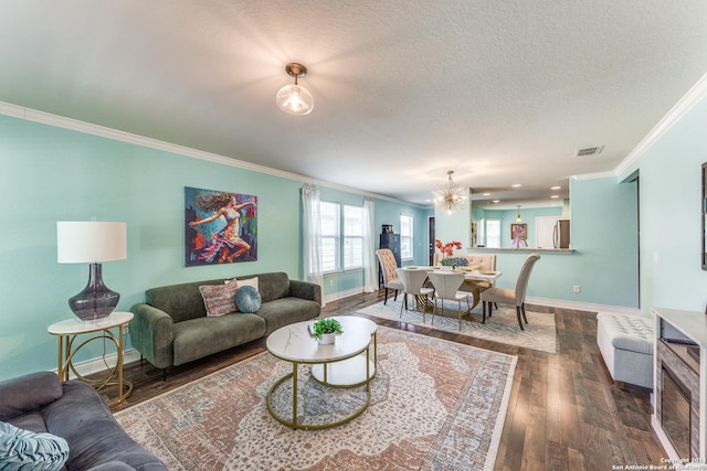 living area featuring a textured ceiling, dark wood-style flooring, visible vents, baseboards, and ornamental molding