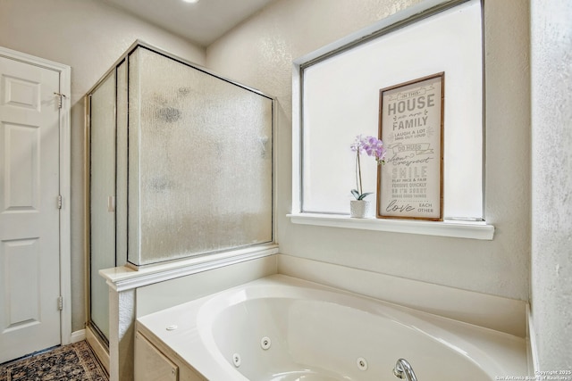 bathroom featuring a whirlpool tub and a stall shower