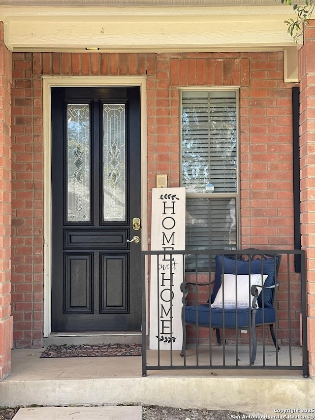 property entrance with brick siding