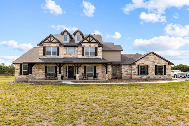 view of front of home with a shingled roof and a front lawn