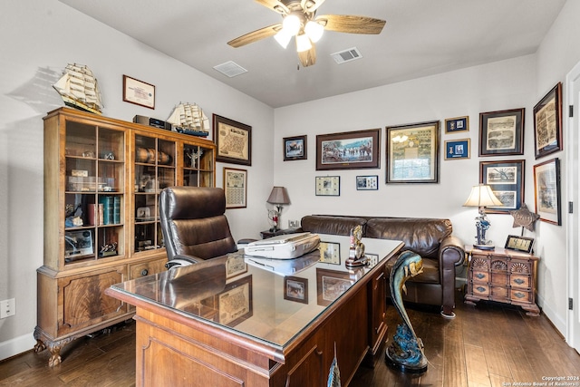 office space with dark wood-style flooring, visible vents, ceiling fan, and baseboards