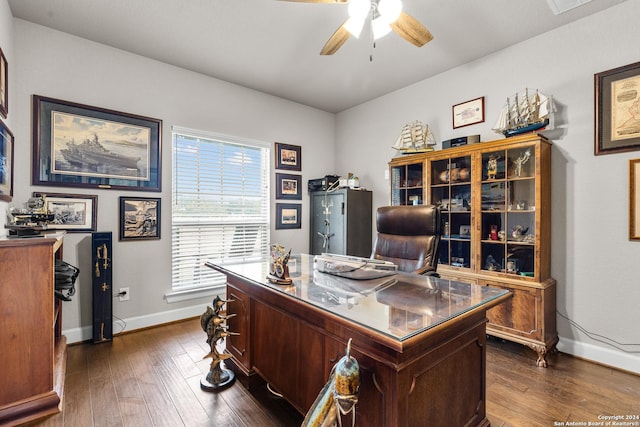 office featuring dark wood-type flooring, ceiling fan, and baseboards